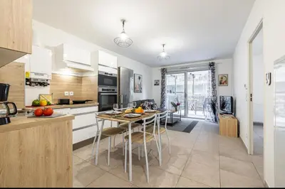 a kitchen with a table and chairs in a room at Appartement nice in Nice