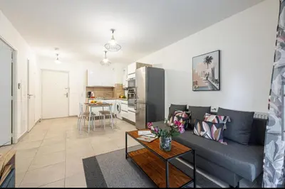 a living room with a couch and a table at Appartement nice in Nice