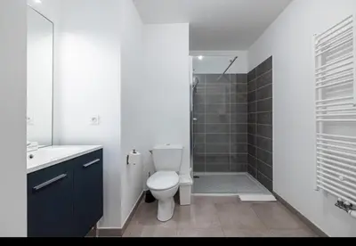 a white bathroom with a toilet and a shower at Appartement nice in Nice