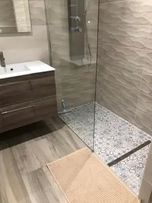 a bathroom with a shower with a sink and a counter at Eros in Nice