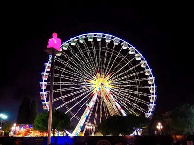 a large ferris wheel at night with a pink duck on top at Appartement proche de Libération avec balcon ensoleillé in Nice