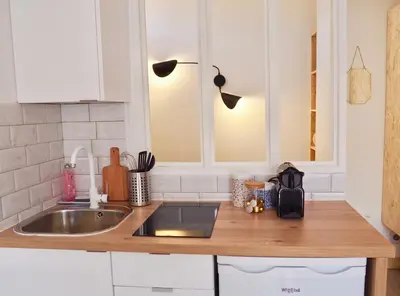 a kitchen with a sink and a counter top at Appartement proche de Libération avec balcon ensoleillé in Nice