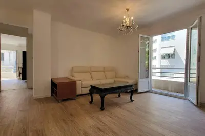 a living room with a couch and a coffee table at Apartment 3 pieces par la mer avec climatisation in Nice