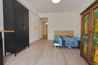 a bedroom with a bed and a large mirror at Apartment 3 pieces par la mer avec climatisation in Nice
