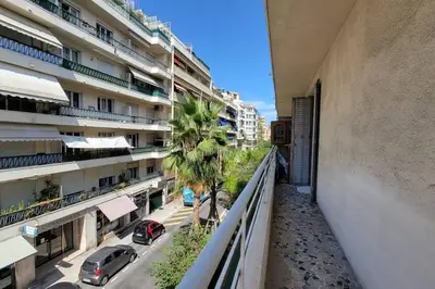 a balcony of a building with cars parked on a street at Apartment 3 pieces par la mer avec climatisation in Nice