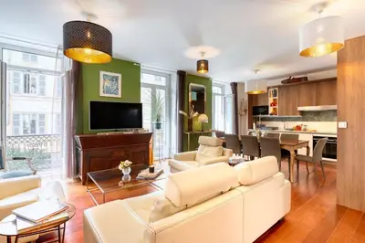 a living room with a white couch and a tv at New vieille ville cimiez Centre Nice in Nice