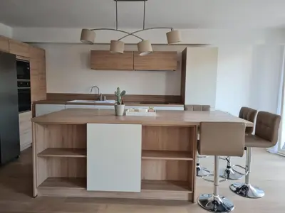 a kitchen with a wooden island with a sink at Charmant 2 pièces Centre Ville in Nice