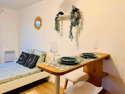 a room with a table with two plates on it at City & Serenity - Studio Proche Gare in Nice