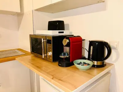 a microwave sitting on top of a kitchen counter at City & Serenity - Studio Proche Gare in Nice