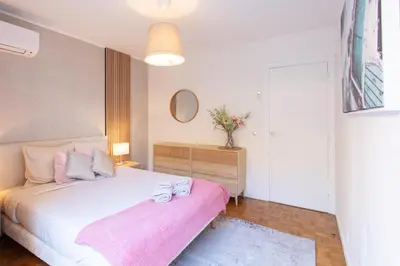 a bedroom with a white bed and a pink blanket at 86m- Spacious 3 room apartment with large terrace in Villefranche-sur-Mer