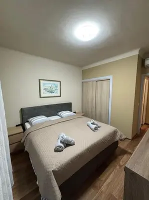 a bedroom with a bed with two pairs of shoes on it at Magnifique 2 pièces à 2 pas de la mer in Nice