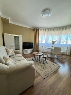 a living room with a couch and a table at Magnifique 2 pièces à 2 pas de la mer in Nice