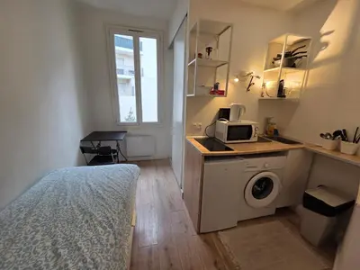 a bedroom with a bed and a washing machine at Studio Niçois Proche Mer in Nice