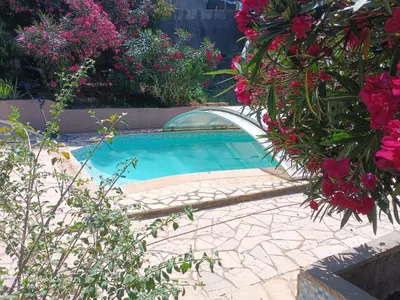 a small swimming pool in a garden with flowers at Studio dans Villa Don Quijote Nice in Nice