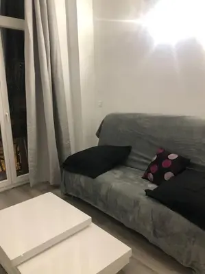 a living room with a couch with pillows on it at Superbe appartement en plein centre ville de Nice! in Nice