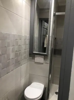 a bathroom with a toilet and a mirror at Superbe appartement en plein centre ville de Nice! in Nice