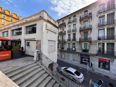 a white car parked on a street next to buildings at Studio gare Nice Clim in Nice