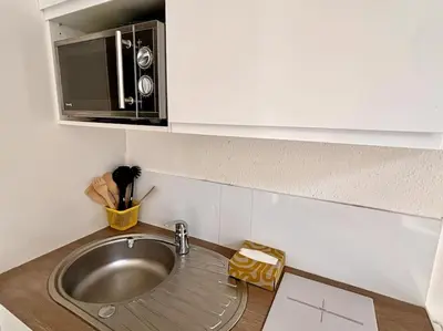 a kitchen counter with a sink and a microwave at Studio gare Nice Clim in Nice