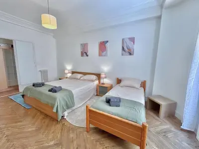a bedroom with two beds in a room at Charmant 3P en centre ville, spacieux et calme in Nice