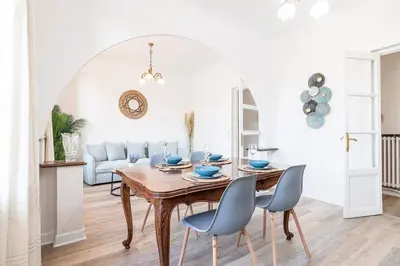 a dining room with a table and chairs at Large Central 2 Bdr & Garage in Nice