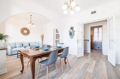 a living room with a wooden table and chairs at Large Central 2 Bdr & Garage in Nice