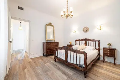 a bedroom with a bed and a dresser and a mirror at Large Central 2 Bdr & Garage in Nice