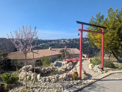 a red torii gate in front of a house at Maison L'Aloé in Nice