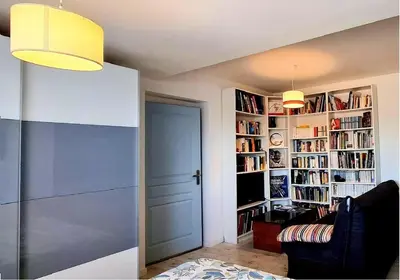 a room with a door and a book shelf with books at Maison L'Aloé in Nice