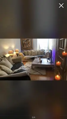 a living room with couches and a table at Room near Nice Port in a shared apartment in Nice