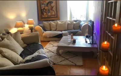 a living room with two couches and a coffee table at Room near Nice Port in a shared apartment in Nice