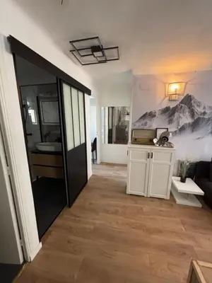 a room with a hallway with a kitchen and a living room at Appartement confortable et cosy sur le port de Nice in Nice