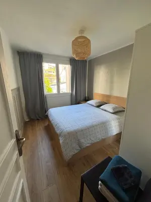 a bedroom with a bed and a window at Appartement confortable et cosy sur le port de Nice in Nice