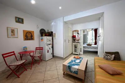 a living room with a couch and a table at Un jardin en Ville in Nice