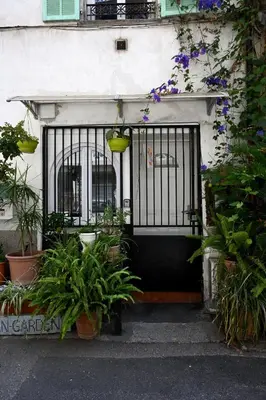 a front door of a house with plants and flowers at Un jardin en Ville in Nice