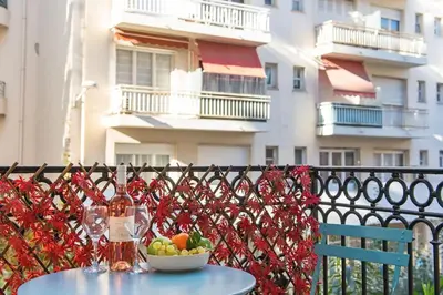 a table with a bowl of fruit on a balcony at - - Superbe Studio avec Balcon - Nice Centre - - in Nice