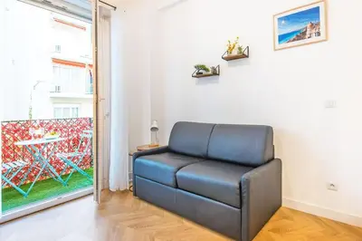 a blue leather chair in a room with a window at - - Superbe Studio avec Balcon - Nice Centre - - in Nice