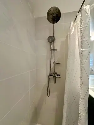 a bathroom with a shower with a shower curtain at Side Ocean View Studio, 24H Check-In and Out, Air Conditioner, Close to Airport in Cagnes-sur-Mer