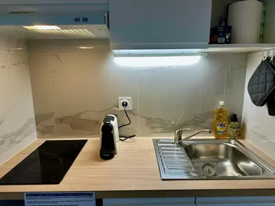 a kitchen with a sink and a counter top with a sink at Side Ocean View Studio, 24H Check-In and Out, Air Conditioner, Close to Airport in Cagnes-sur-Mer
