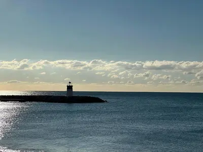 a lighthouse on an island in the ocean at Side Ocean View Studio, 24H Check-In and Out, Air Conditioner, Close to Airport in Cagnes-sur-Mer