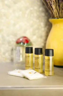 three bottles of essential oils on a counter with a vase at 4 pièces vue mer, 6 pers, balcon, WiFi, garage in Villefranche-sur-Mer