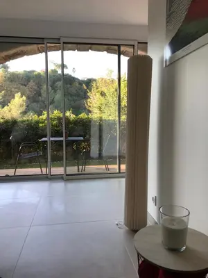 a hallway with sliding glass doors in a house at La Paillissade in Cagnes-sur-Mer