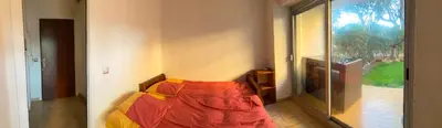 a bedroom with a bed and a large window at Cros de Cagnes Pins Sud Évasion in Cros-de-Cagnes