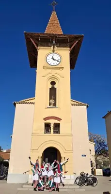 a group of children dancing in front of a clock tower at Cros de Cagnes Pins Sud Évasion in Cros-de-Cagnes