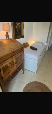 a small bedroom with a bed and a dresser at t3 cagnes sur mer in Cagnes-sur-Mer