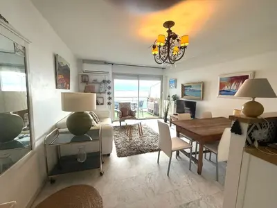 a living room with a table and a dining room at t3 cagnes sur mer in Cagnes-sur-Mer
