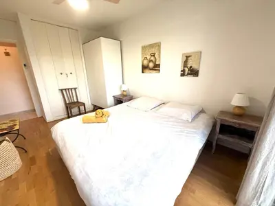 a bedroom with a large bed with a teddy bear on it at t3 cagnes sur mer in Cagnes-sur-Mer
