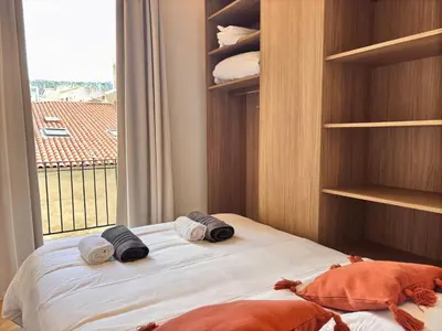a bedroom with a bed with a window and towels at Ze Perfect Place - Splendide Appart 2 Chb Garibaldi in Nice