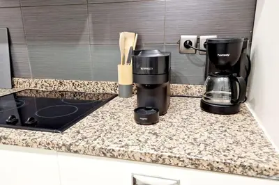 a kitchen counter with a coffeemaker and a coffee maker at Sunny Escape in Nice