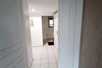 a hallway with a white door and a white tile floor at Sunny Escape in Nice