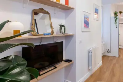 a living room with a tv and a mirror at L59 Appartment La Loge Vieux Nice, central AC & WIFI in Nice